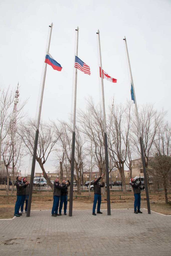 Expedition 58 prime and backup crew members raise the flags of Russia, the United States, Canada and Kazakhstan