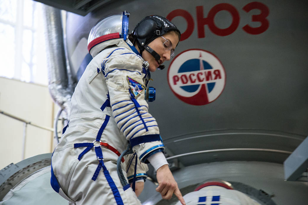 Christina Koch of NASA boards a Soyuz spacecraft simulator