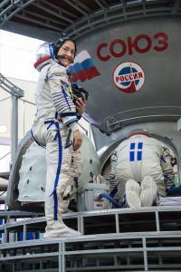Christina Koch of NASA boards a Soyuz spacecraft simulator
