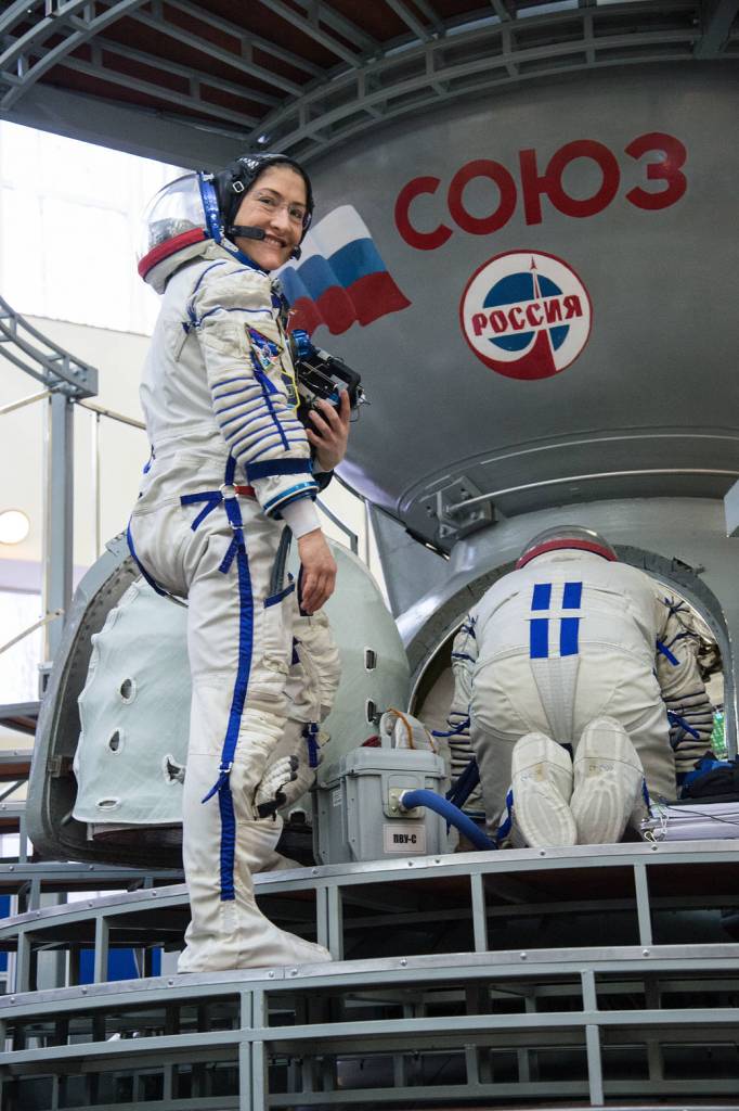 Christina Koch of NASA boards a Soyuz spacecraft simulator