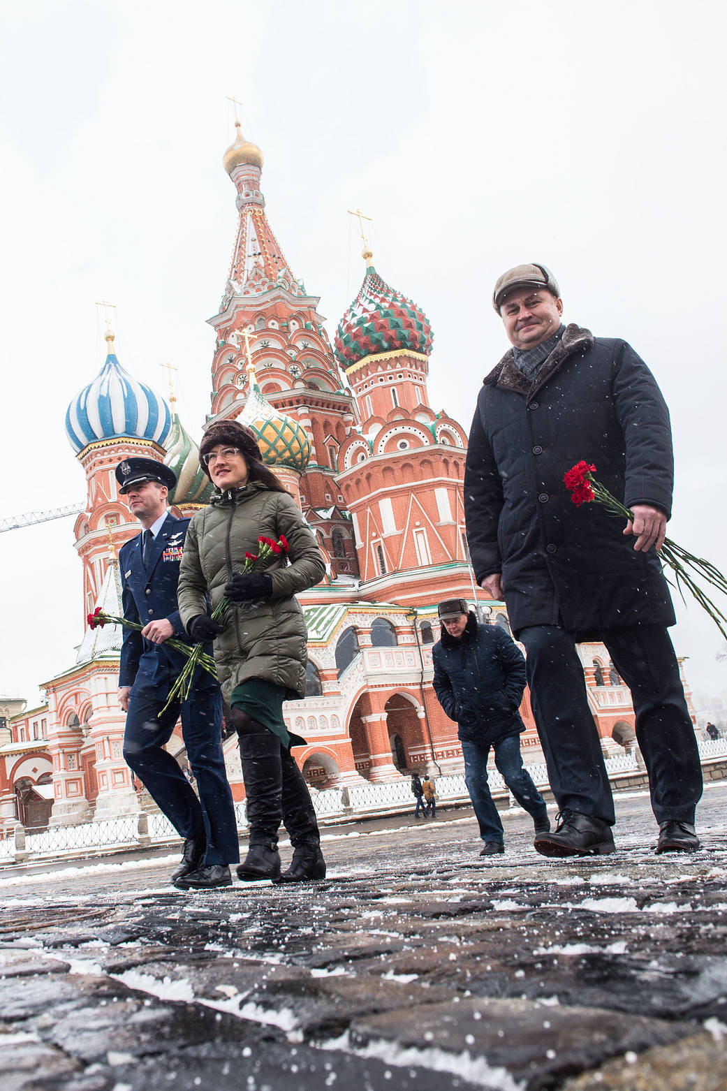 Expedition 59 crew members walk toward the Kremlin Wall