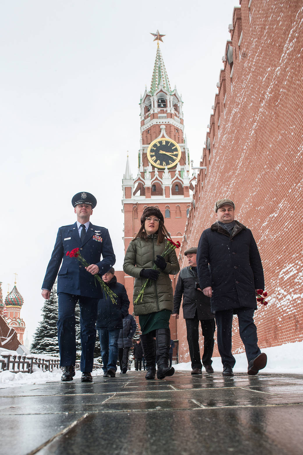 Expedition 59 crew members walk along the Kremlin Wall