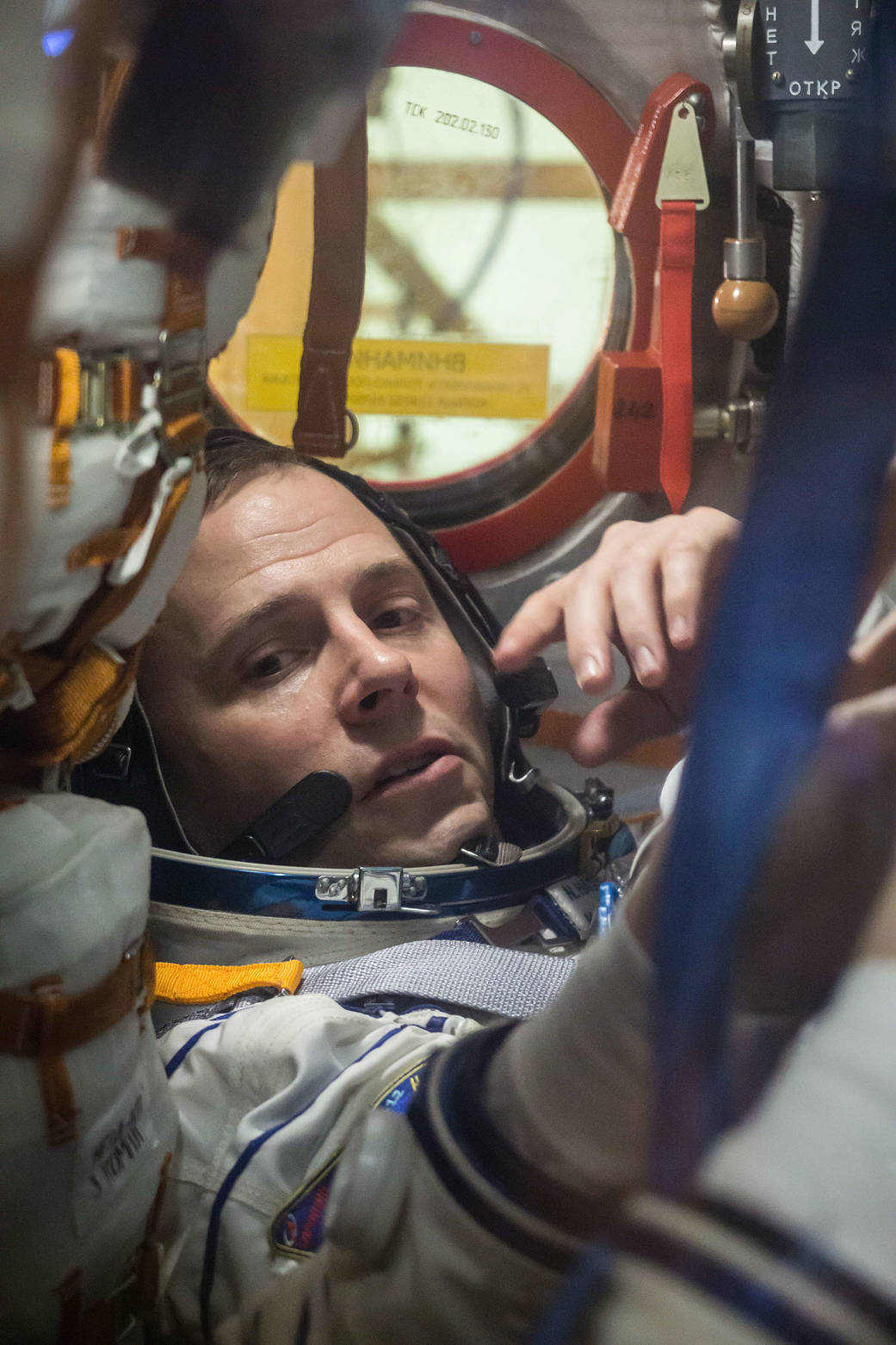 Nick Hague of NASA works inside the Soyuz MS-12 spacecraft