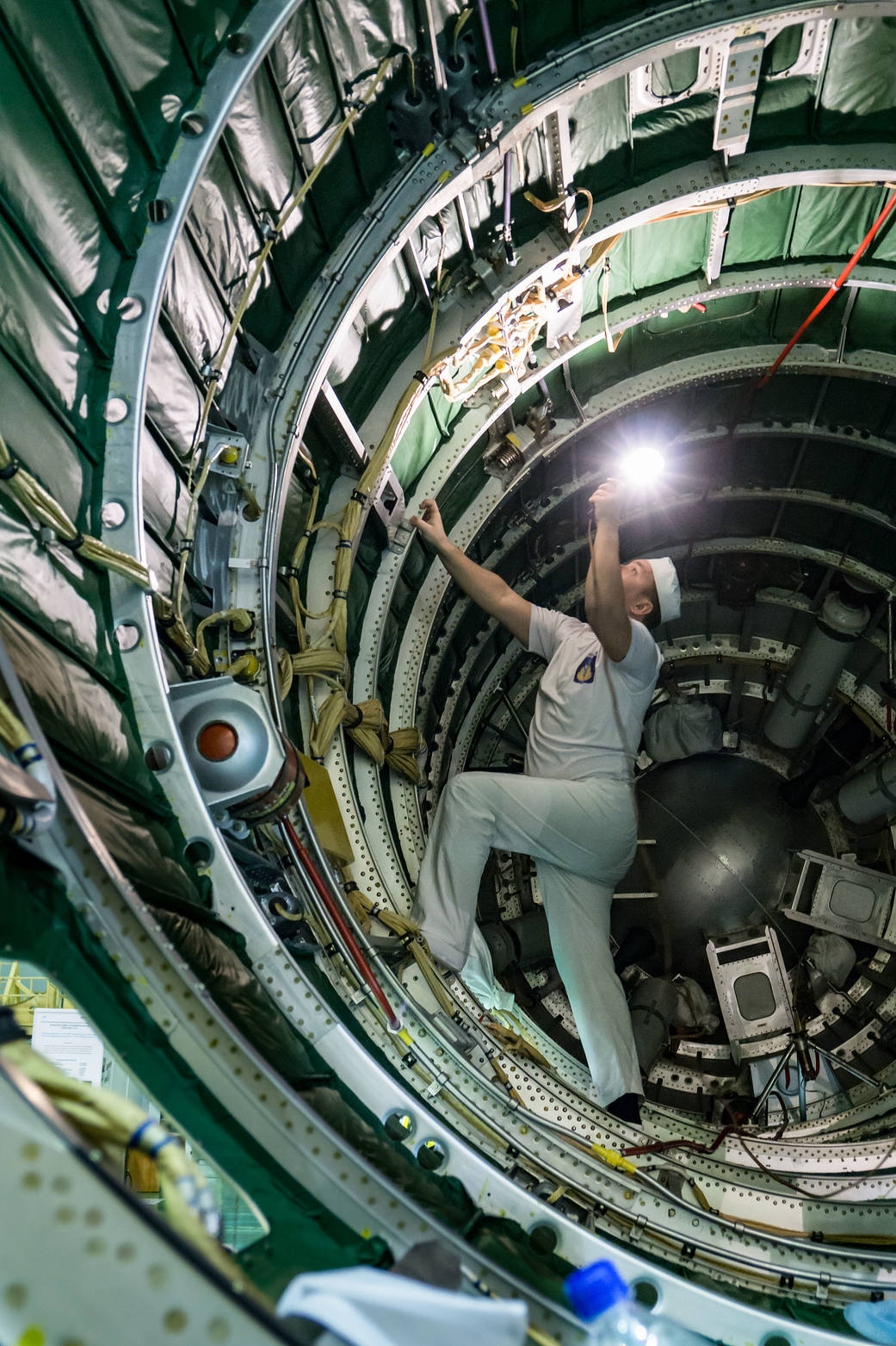 A technician inspects the Soyuz booster