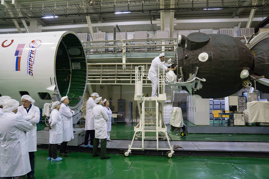 Technicians check of the alignment of the Soyuz MS-12 spacecraft