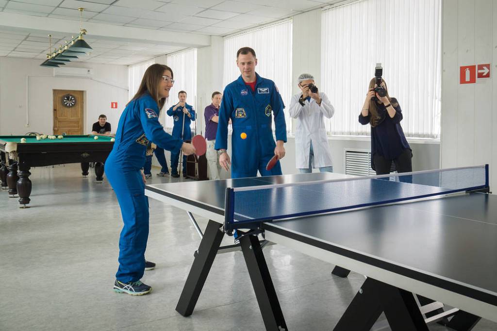 NASA astronauts Christina Koch and Nick Hague play a game of ping-pong