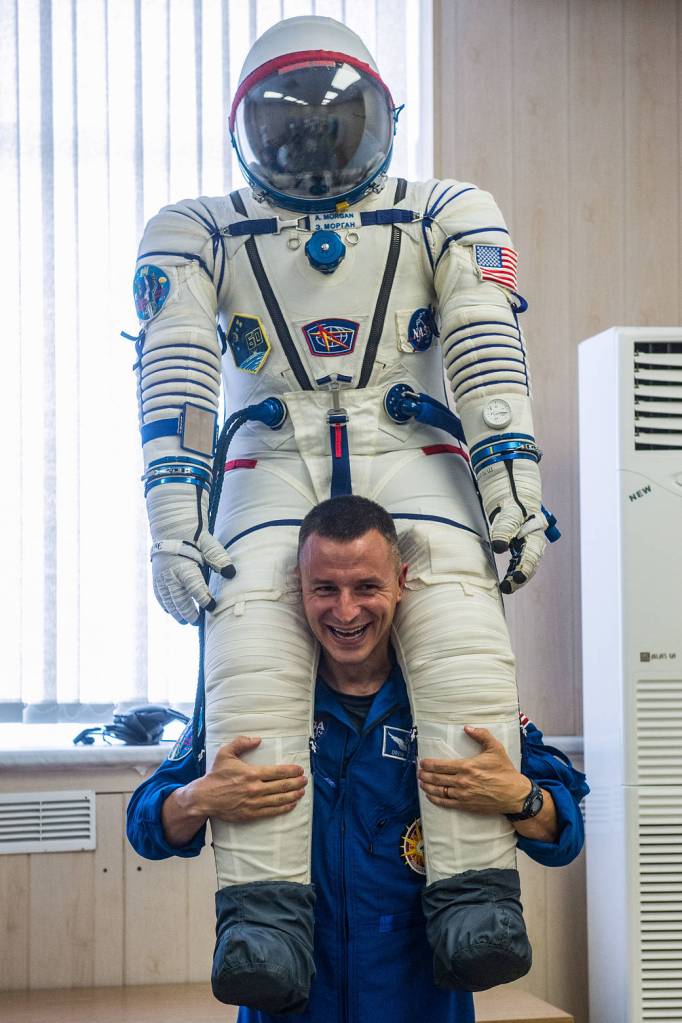 Expedition 60 crewmember Drew Morgan of NASA poses with his Sokol launch and entry suit
