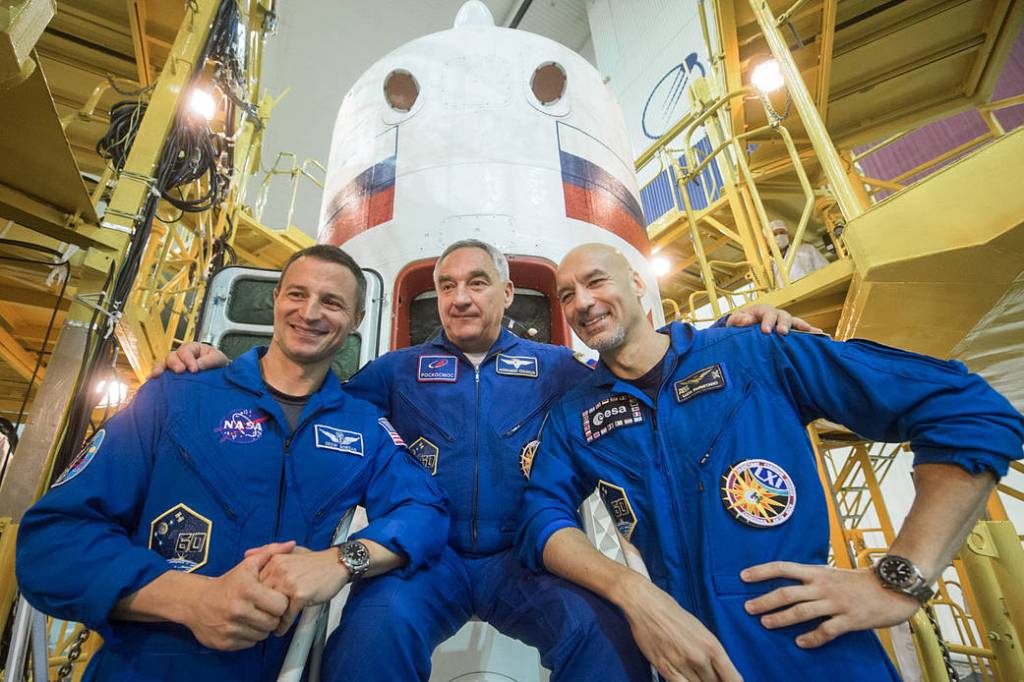 Expedition 60 crewmembers in front of the Soyuz MS-13 spacecraft