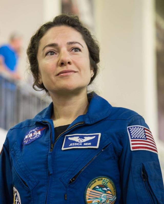 Expedition 61 crewmember Jessica Meir of NASA listens to a reporter's question