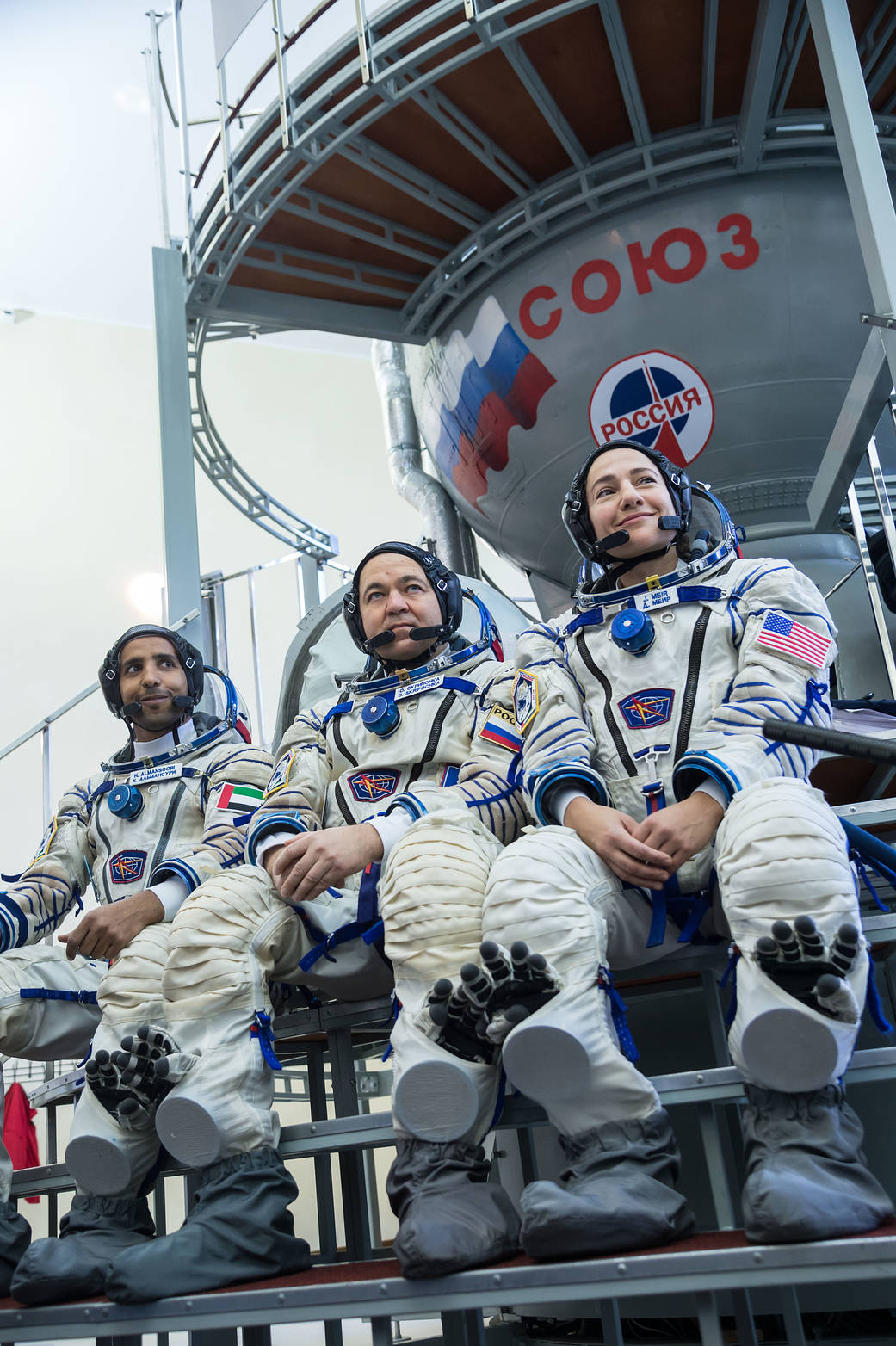 Spaceflight participant Hazzaa Ali Almansoori, Oleg Skripochka and Jessica Meir listen to reporters’ questions during crew quali