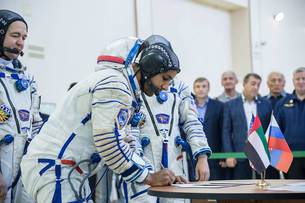 Spaceflight participant Hazzaa Ali Almansoori signs in for the second day of crew qualification exams