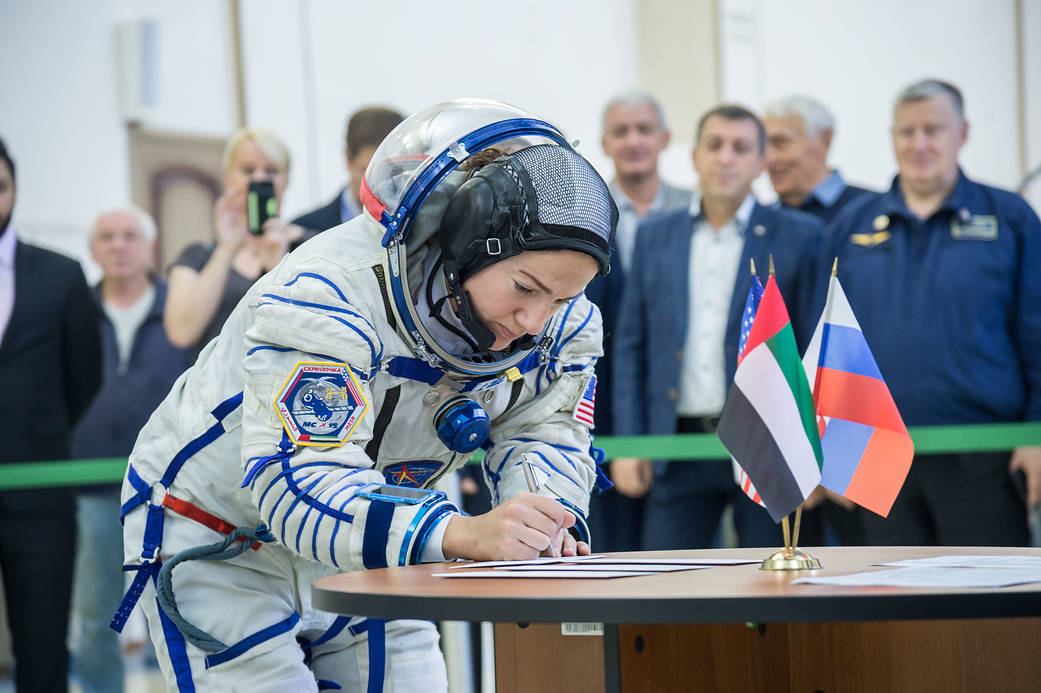 Jessica Meir signs in for the second day of crew qualification exams