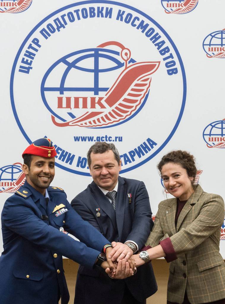 Spaceflight participant Hazzaa Ali Almansoori, Oleg Skripochka and Jessica Meir pose for pictures