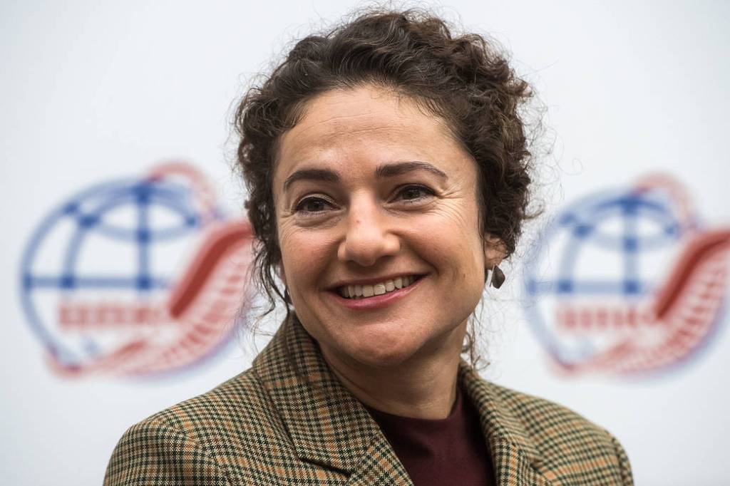 Jessica Meir listens to a reporter’s question during a pre-launch news conference