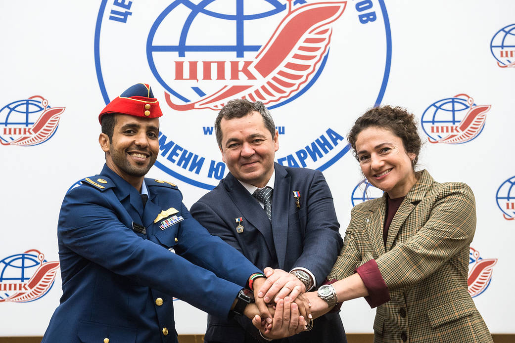 Spaceflight participant Hazzaa Ali Almansoori, Oleg Skripochka and Jessica Meir pose for pictures