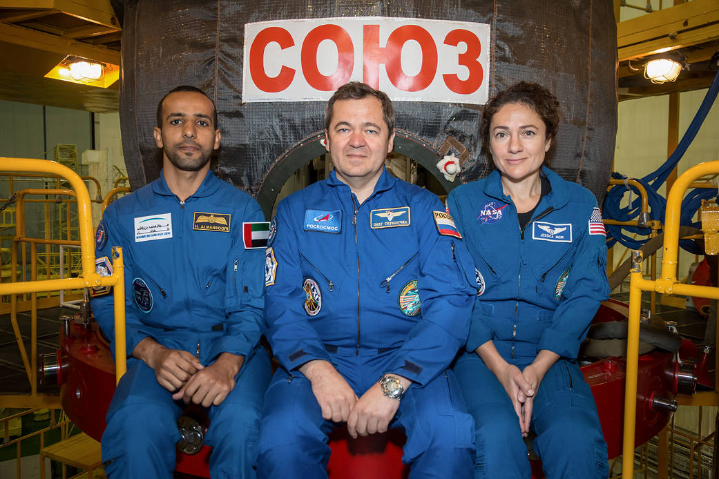 Hazzaa Ali Almansoori, Oleg Skripochka and Jessica Meir in front of their Soyuz MS-15 spacecraft