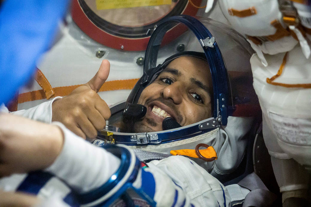 Spaceflight participant Hazzaa Ali Almansoori flashes a thumbs up as he runs through procedures aboard the Soyuz MS-15 spacecraf