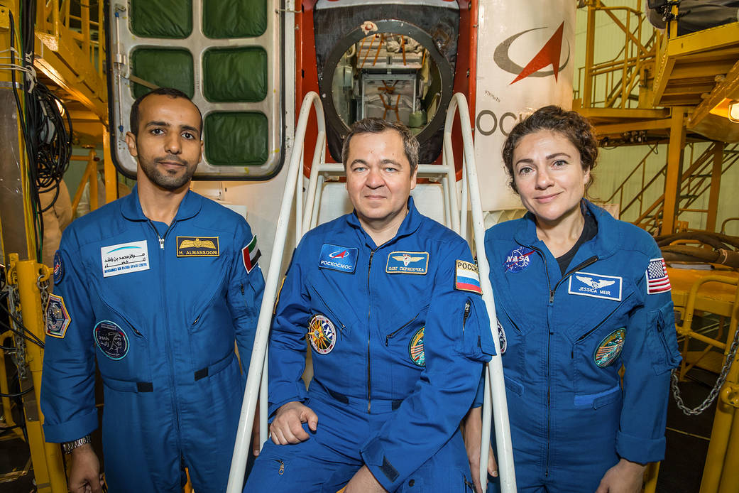 The next International Space Station crew poses in front of Soyuz spacecraft