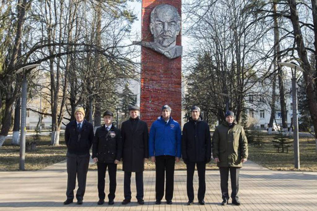 Expedition 63 backup and prime crewmembers in front of the statue of Vladimir Lenin