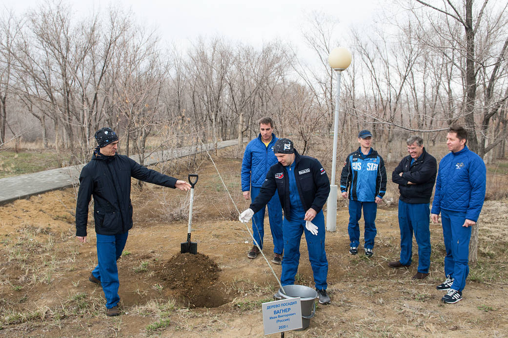 Expedition 63 crewmember Ivan Vagner plants a tree