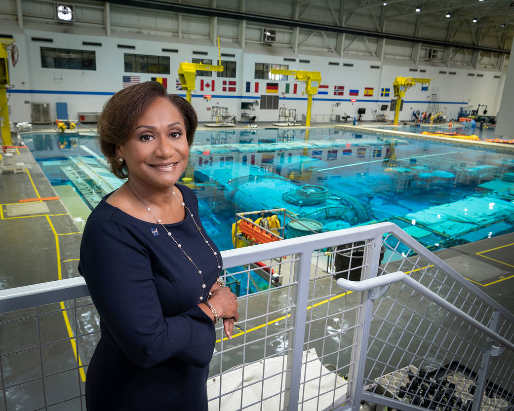Johnson Space Center Director Vanessa Wyche standing in front of the Neutral Buoyancy Laboratory pool. 
