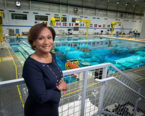 Johnson Space Center Director Vanessa Wyche standing in front of the Neutral Buoyancy Laboratory pool.