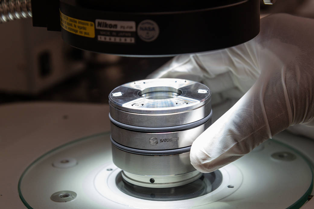 A Hayabusa2 sample canister containing sample fragments of the asteroid Ryugu is transferred from JAXA to NASA.