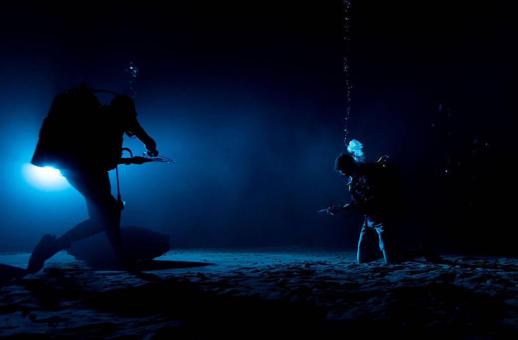 Divers at the Neutral Buoyancy Laboratory (NBL) in Houston are setting the stage for future moonwalk training by simulating lunar lighting conditions. 