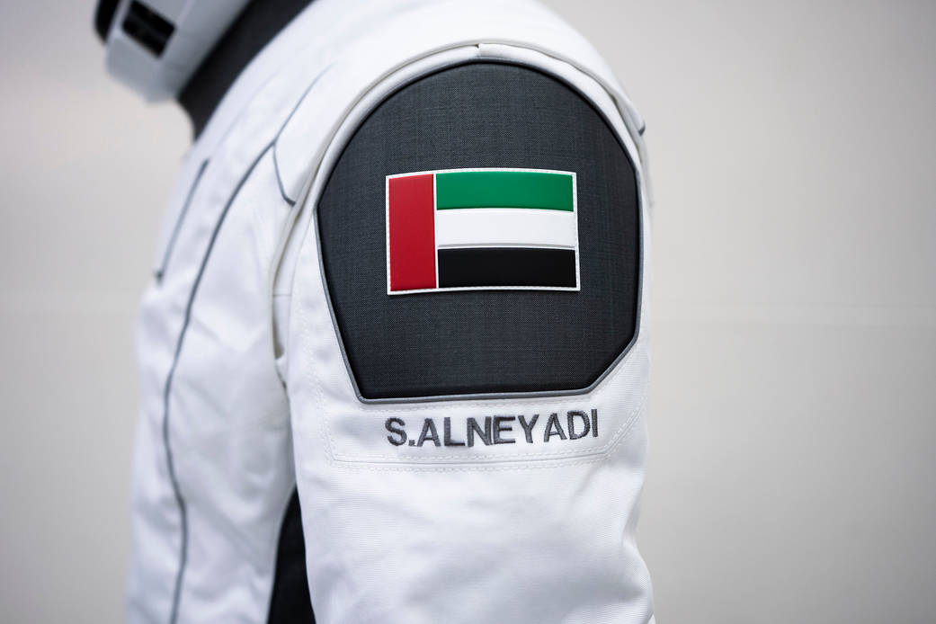 A SpaceX launch and entry suit bears a United Arab Emirates flag