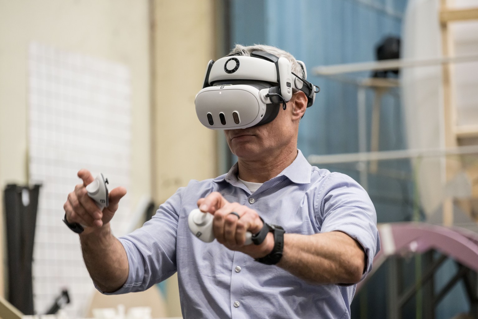 NASA astronaut Mark Vande Hei wears a virtual reality headset and holds motion controllers while exploring a full configuration of the Gateway lunar space station in virtual reality.