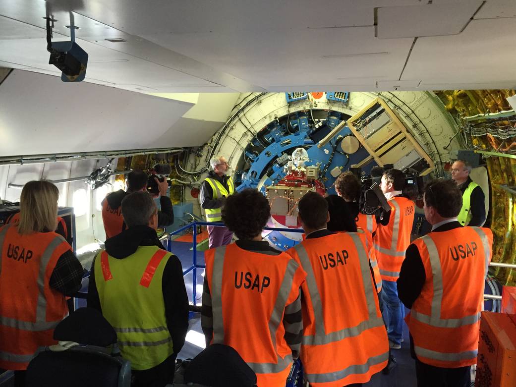 Representatives of New Zealand media onboard SOFIA during a tour, hearing NASA SOFIA Mission Manager Ed Harmon (back, left) and 