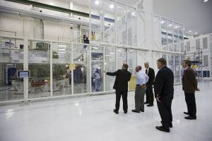 Charles Bolden, NASA administrator, center, is shown the Orion capsule that will make an uncrewed flight test in 2014.