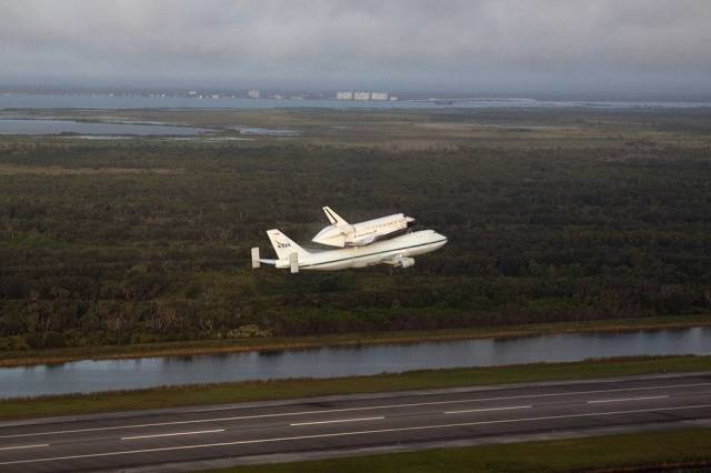Space shuttle Endeavour, mounted atop NASA's Shuttle Carrier Aircraft or SCA, is airborne at 7:22 a.m. EDT from the Shuttle Landing Facility at NASA's Kennedy Space Center in Florida.