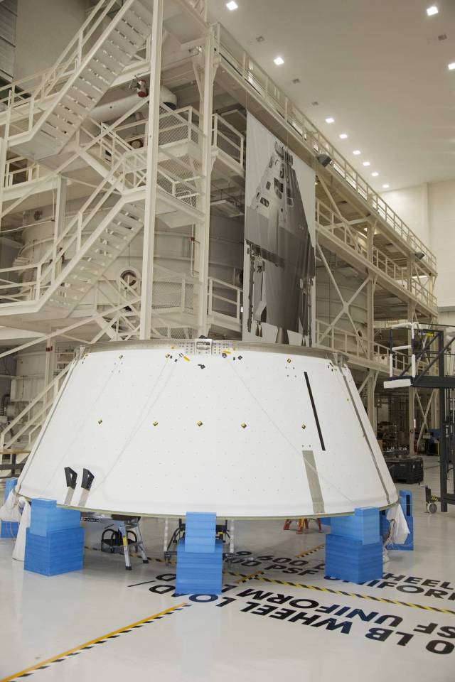 Inside the Operations and Checkout Building high bay at NASA’s Kennedy Space Center in Florida, the spacecraft adapter cone for the Orion spacecraft is positioned on special protective blocks for processing work. 