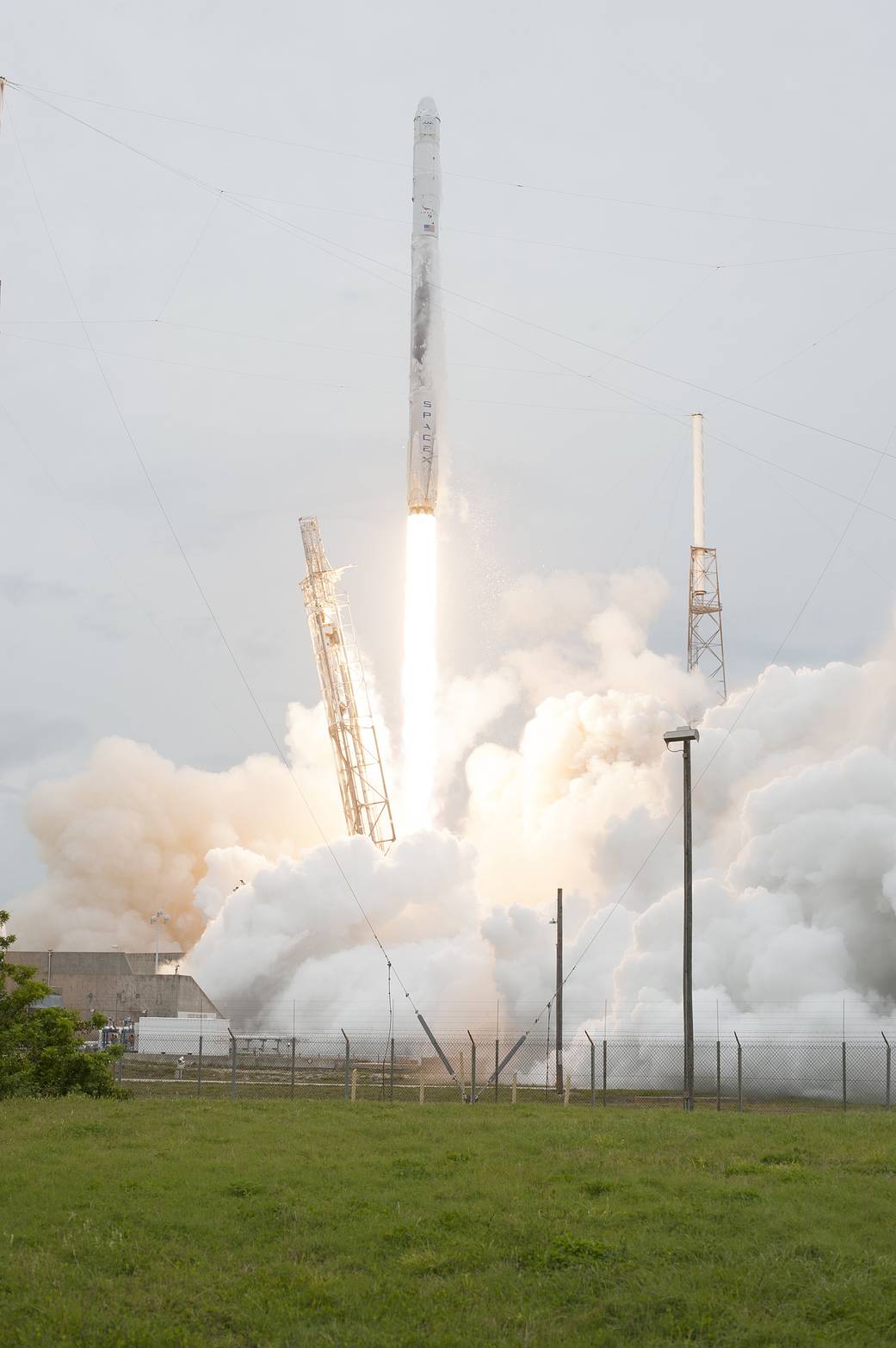 The SpaceX-3 mission soars into the clouds over Space Launch Complex 40 on Cape Canaveral Air Force Station aboard a Falcon 9 rocket, carrying the Dragon resupply spacecraft to the International Space Station.