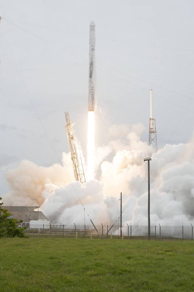 The SpaceX-3 mission soars into the clouds over Space Launch Complex 40 on Cape Canaveral Air Force Station aboard a Falcon 9 rocket, carrying the Dragon resupply spacecraft to the International Space Station.