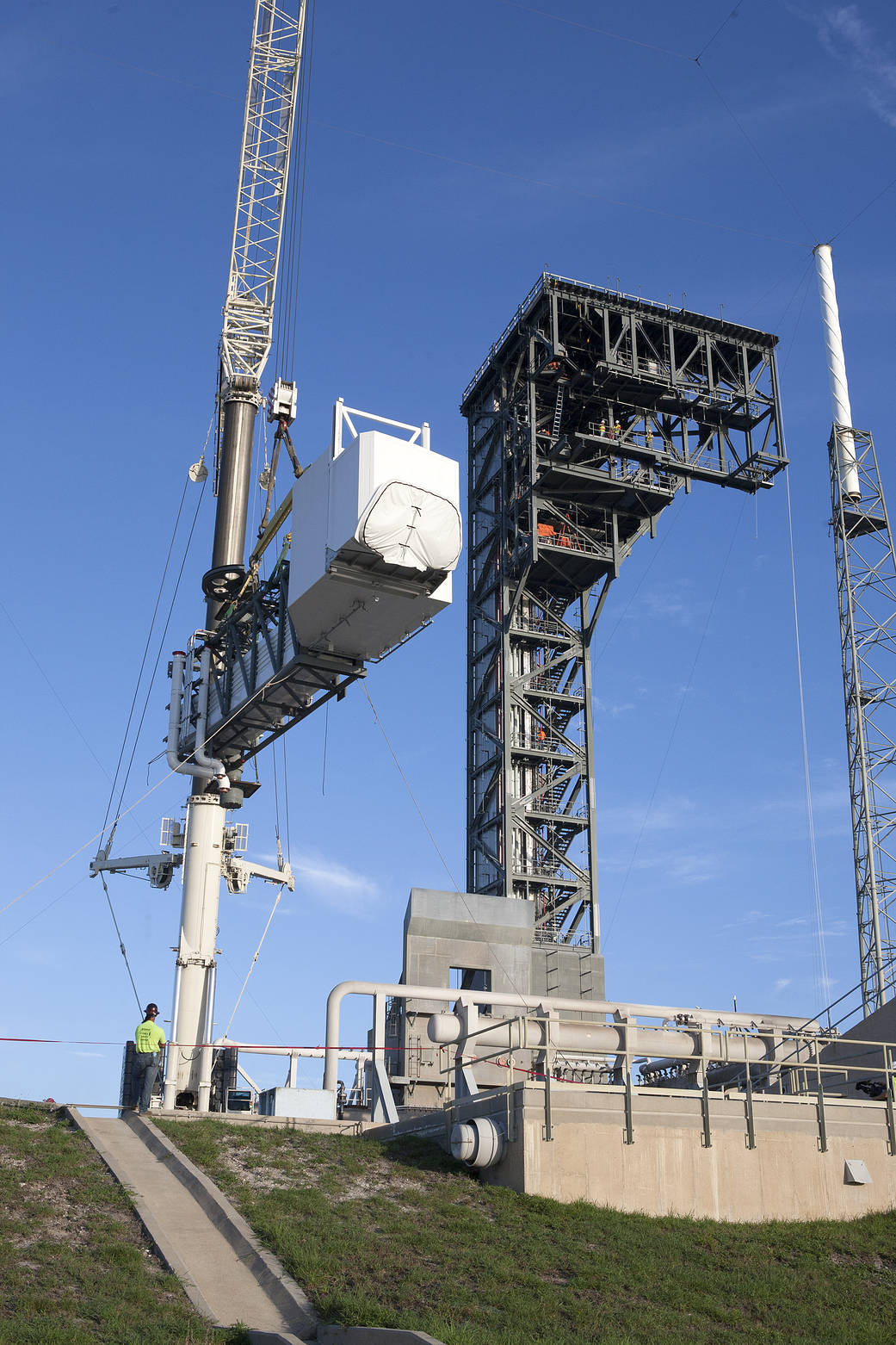 A crane lifts the Crew Access Arm and White Room for Boeing's CST-100 Starliner spacecraft to be attached to the Crew Access Tower at Cape Canaveral Air Force Station’s Space Launch Complex 41.