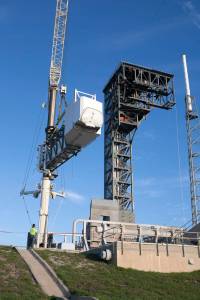 A crane lifts the Crew Access Arm and White Room for Boeing's CST-100 Starliner spacecraft to be attached to the Crew Access Tower at Cape Canaveral Air Force Station’s Space Launch Complex 41.