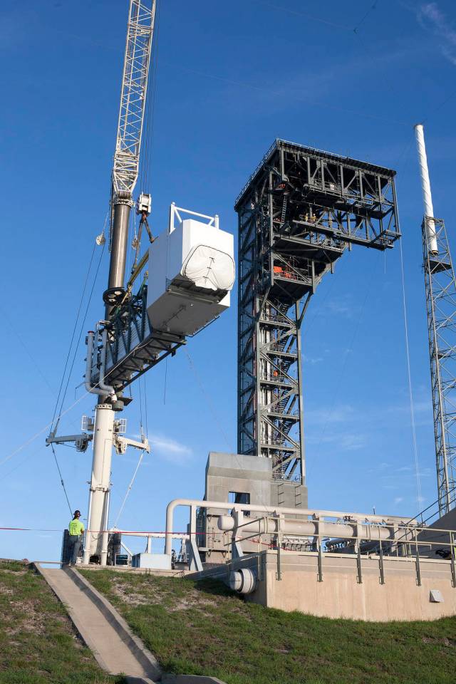 A crane lifts the Crew Access Arm and White Room for Boeing's CST-100 Starliner spacecraft to be attached to the Crew Access Tower at Cape Canaveral Air Force Station’s Space Launch Complex 41. 