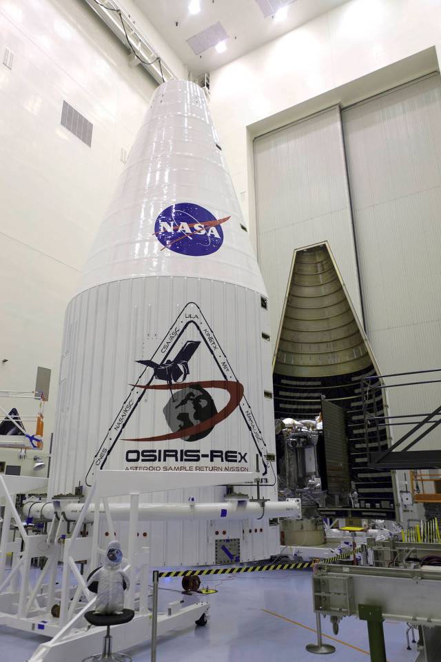 Inside the Payload Hazardous Servicing Facility at NASA's Kennedy Space Center in Florida, the agency’s OSIRIS-REx spacecraft is encapsulated in its payload fairing. 