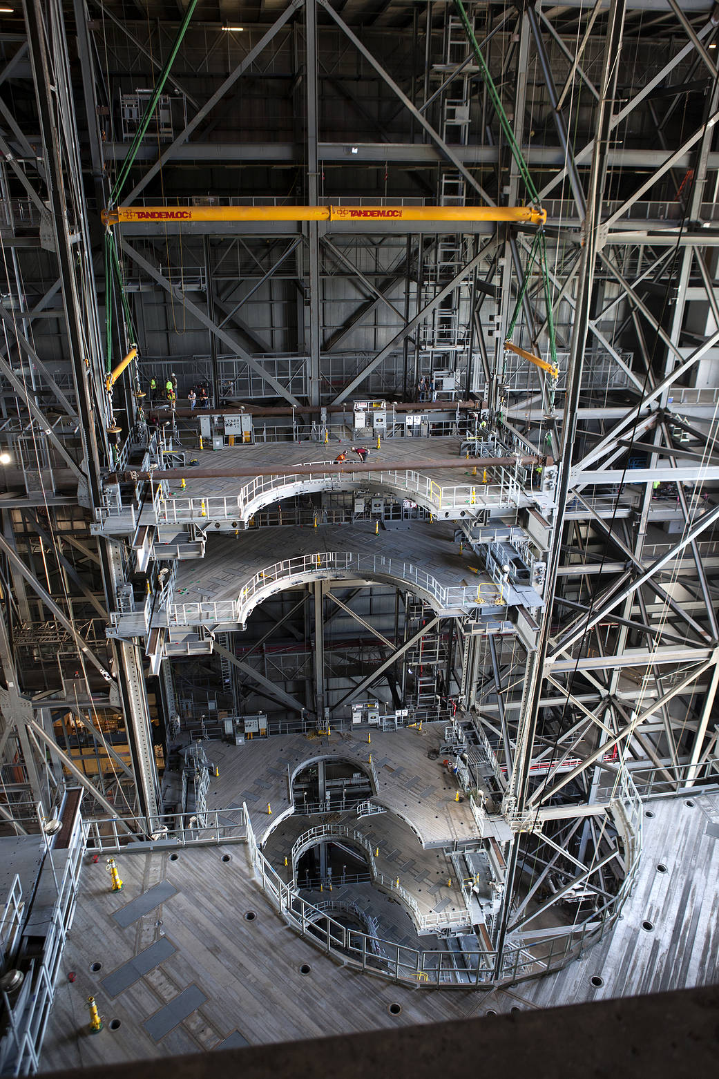A heavy-lift crane lowers the second half of the D-level work platforms for NASA’s Space Launch System (SLS) rocket, into position for installation in High Bay 3 in the Vehicle Assembly Building (VAB) at the agency’s Kennedy Space Center in Florida.
