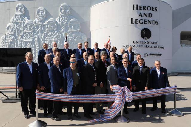 Dignitaries, including members of the U.S. Astronaut Hall of Fame, prepare to cut a ceremonial ribbon opening the Heroes and Legends attraction at the Kennedy Space Center Visitor Complex. 