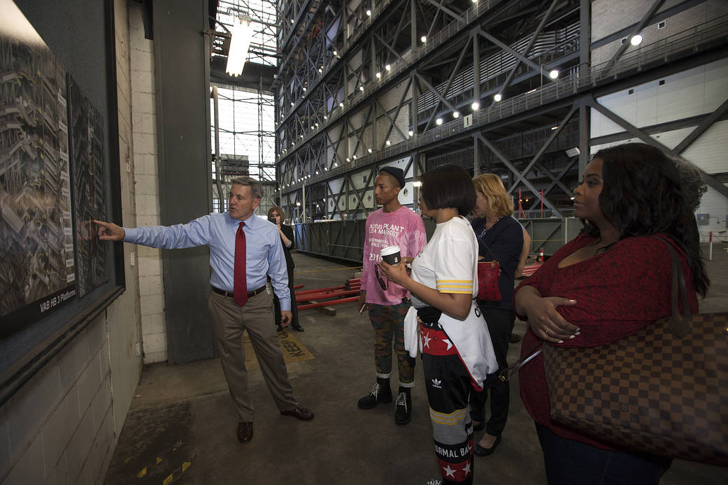 Kennedy Space Center Director Bob Cabana points to a display during a tour for cast and crew members of the upcoming motion picture "Hidden Figures."
