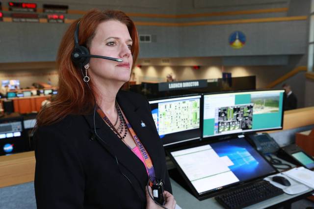 NASA Launch Director Charlie Blackwell-Thompson stands next to her console in Firing Room 1 at the Kennedy Space Center's Launch Control Center during a countdown simulation for Artemis-1. 
