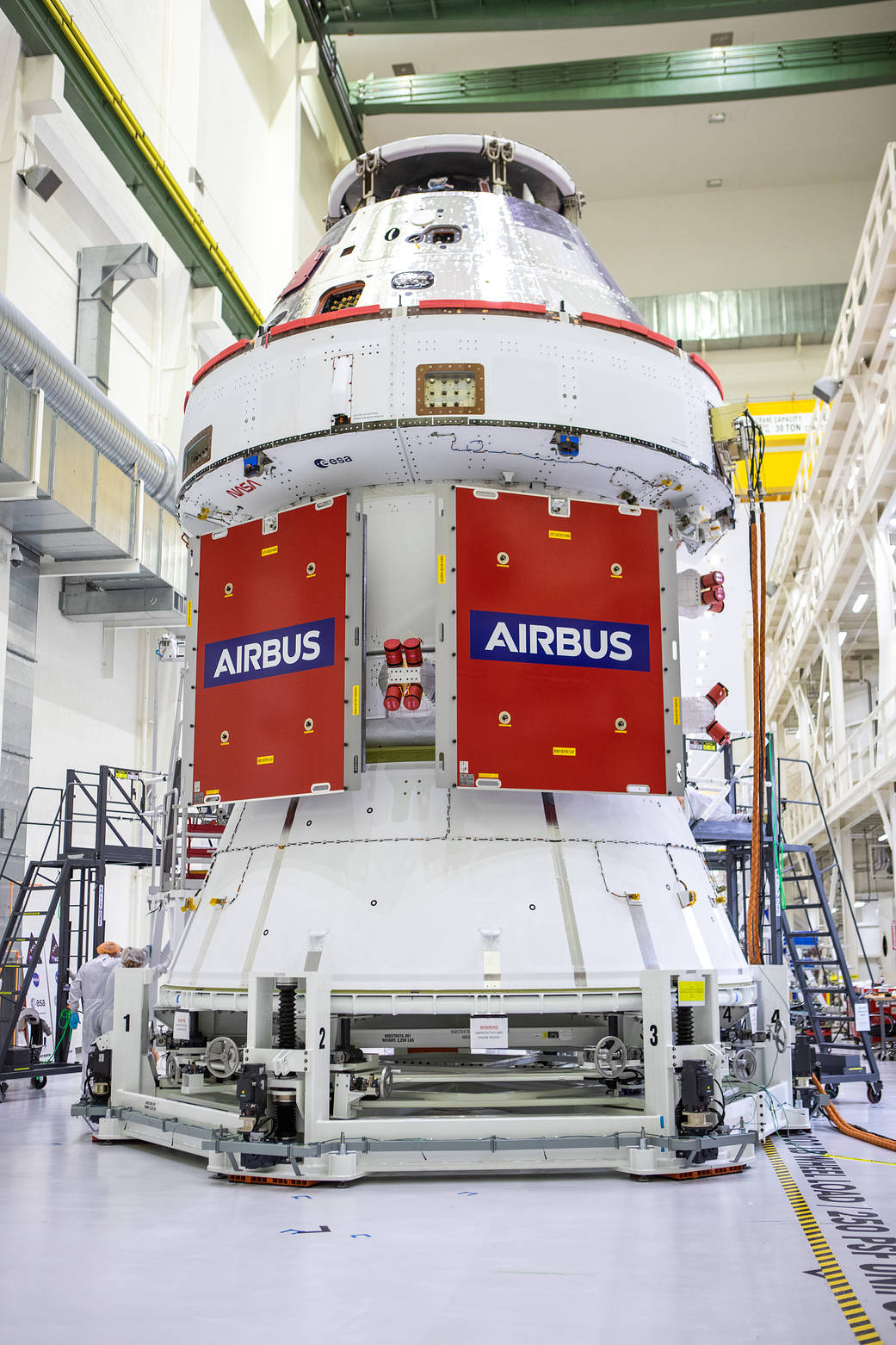 In view, protective covers have been placed over two solar array wings after installation was completed on the Orion spacecraft for Artemis I.