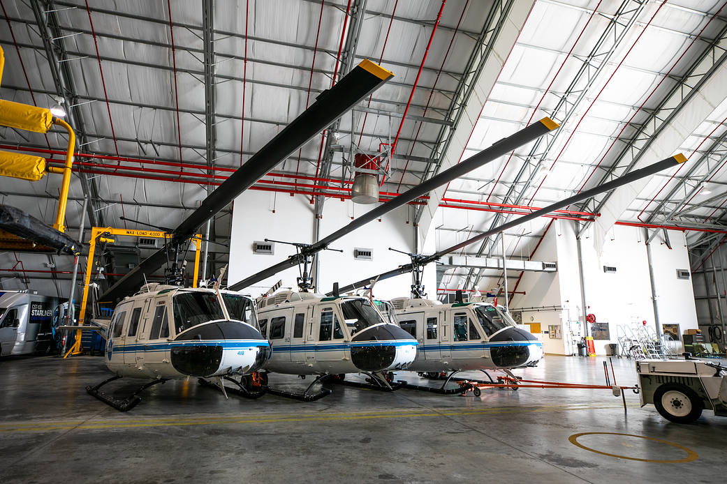 The three Bell Huey 2 helicopters utilized by Kennedy Space Center’s Flight Operations team for security purposes are photographed inside the Launch and Landing Facility hangar.
