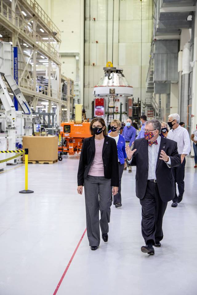 Catherine Koerner, in front at left, NASA Orion Program manager, along with senior managers from Orion and Lockheed Martin, tour the Neil Armstrong Operations and Checkout Building at Kennedy Space Center.