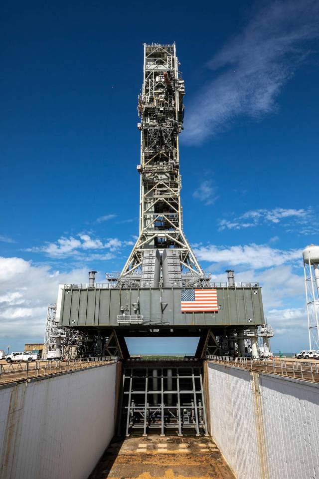 A view of the mobile launcher for Artemis I with the two side flame deflectors positioned underneath during a countdown demonstration test at Launch Pad 39B at Kennedy Space Center.