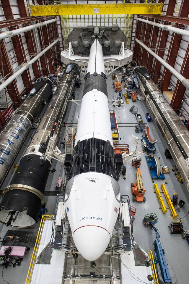 A SpaceX Falcon 9 rocket and Crew Dragon Resilience for NASA SpaceX’s Crew-1 mission are seen inside the SpaceX Hangar at NASA’s Kennedy Space Center in Florida.