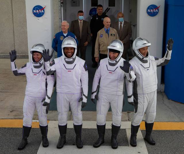 The NASA SpaceX Crew-1 astronauts emerge from the Neil Armstrong Operations and Checkout Building at NASA’s Kennedy Space Center in Florida on Nov. 15, 2020. 
